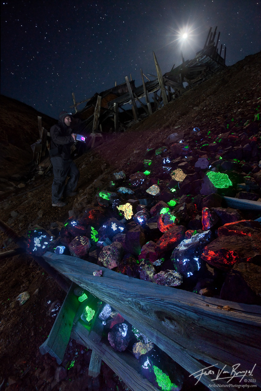 A curious rock collector explores piles of fluorescent minerals found in the tailings of the Pacific Tungsten Mine near Darwin...