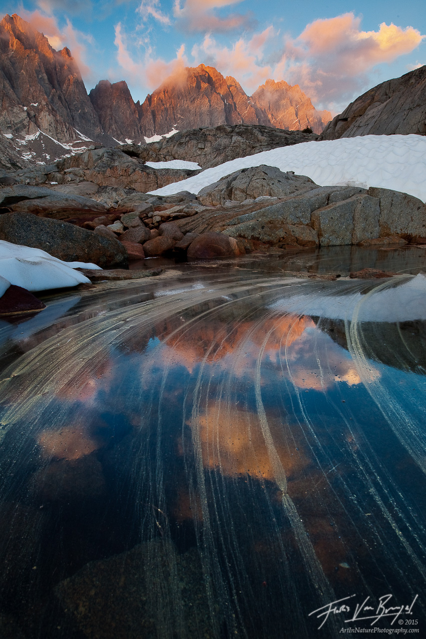 Pollen streaks in a small alpine tarn in the Dusy Basin lead the eyes towards the impressive Thunderbolt Peak and North Palisade...
