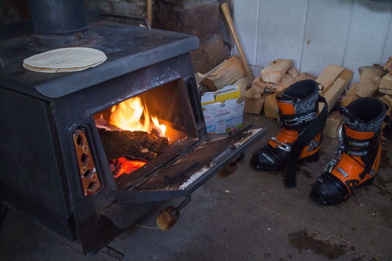Drying out ski boots, and making a quesadilla, on the wood stove.