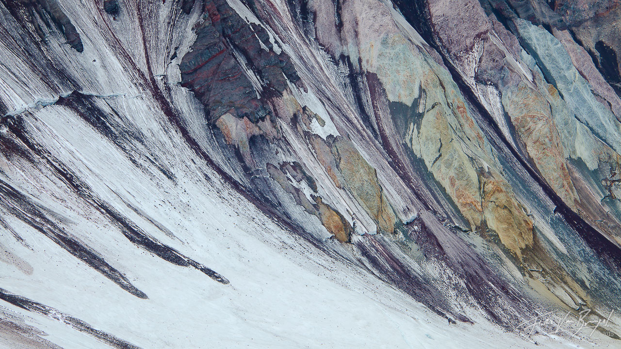Colorful layers of rock on the inside of Washington's Mt St Helens' crater, seen from the rim.