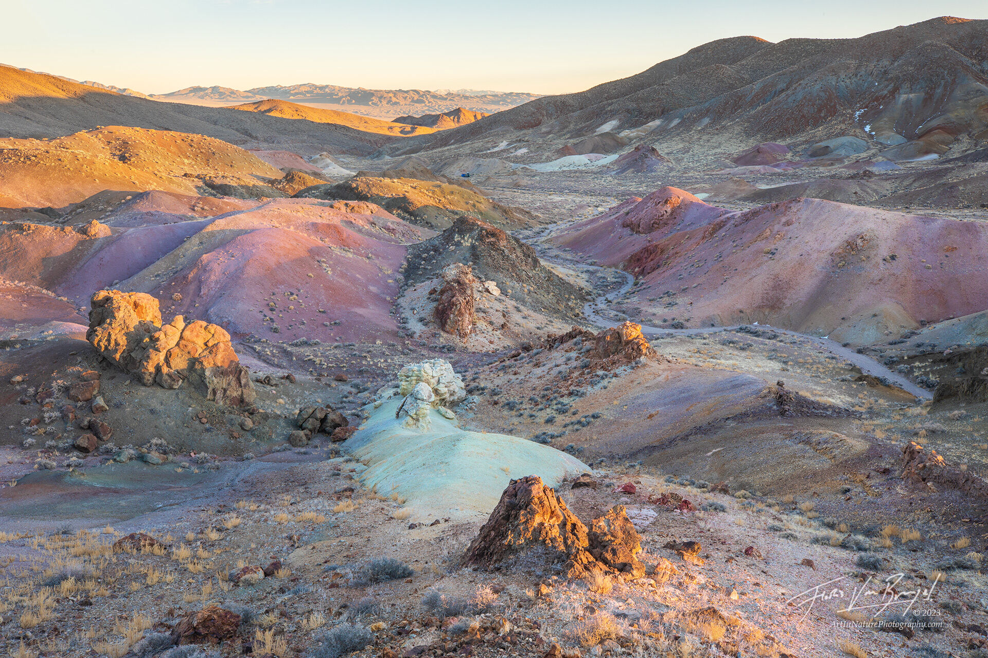 Last light on a landscape of colorfully painted hills in Nevada's Monte Cristo mountains.