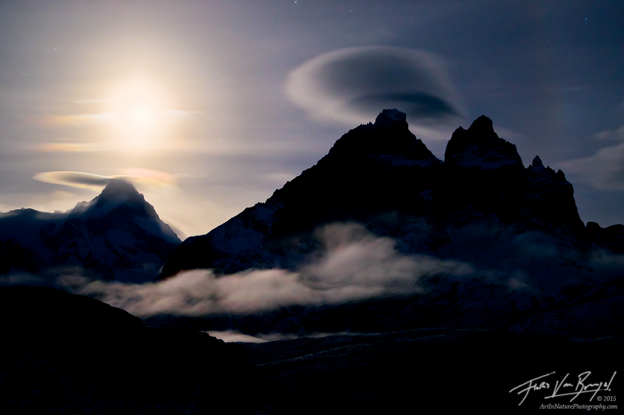 Moonset illuminates lenticular clouds over Cuernos del Paine in Chile's Torres del Paine National Park.